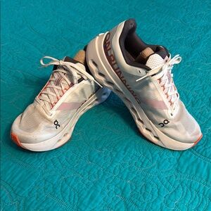 On Running White and Orange Athletic Shoes Sleek Design